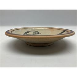 Studio pottery bowl, probably by Svend Bayer of Wenford Bridge, the stoneware body of shallow circular footed form with brushwork decoration of a stylised bird figure in grey upon peach ground within bands of iron red, unmarked, D18.5cm