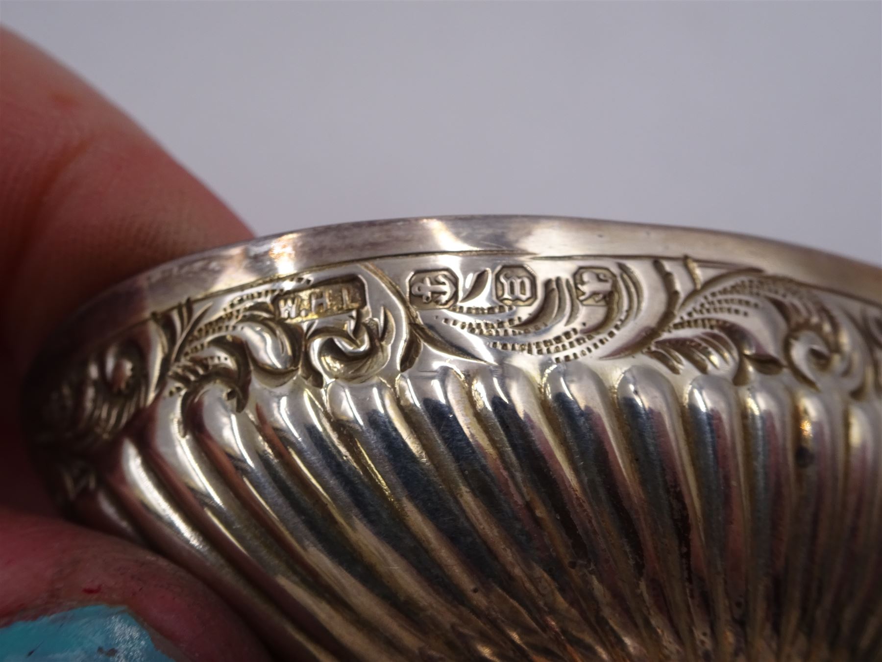 Pair of Victorian silver open salts, of part fluted navette form, with engraved foliate decoration, upon oval stepped foot, hallmarked W H Lyde, Birmingham 1896, H3.5cm, together with a pair of silver salt spoons, with leaf shaped bowls and ball finials, hallmarked Joseph Gloster, Birmingham 1897, together with a pair of Victorian silver open salts, of circular form, with shaped rim and embossed scroll and lattice decoration to the gilded bowl, together with pair of matching silver salt spoons, hallmarked Albert Sydenham, Birmingham 1899, both sets within tooled leather, velvet and silk lined fitted cases