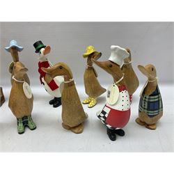 Quantity of the Duck Company UK DCUK carved bamboo root ducks, modelled wearing rain hats and rain boots etc, together with other similar carved wood ducks, tallest H26cm
