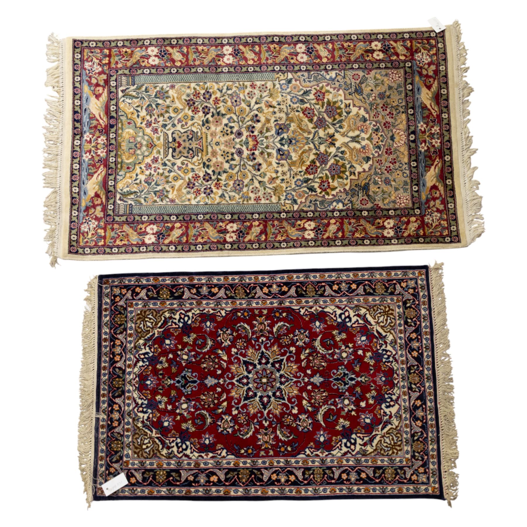 Two Central Persian rugs, ivory ground with a symmetrical foliate and floral design around a shaped cartouche medallion with a red floral and bird motif border with contrasting guard stripes, 142x76cm, Central Persian Kashan rug, crimson central field with a floral and foliate design with a stylized rosette medallion incorporating palmettes and scrolling vine work, enclosed by a dark navy border and multiple guard stripes, 117x68cm, (2)