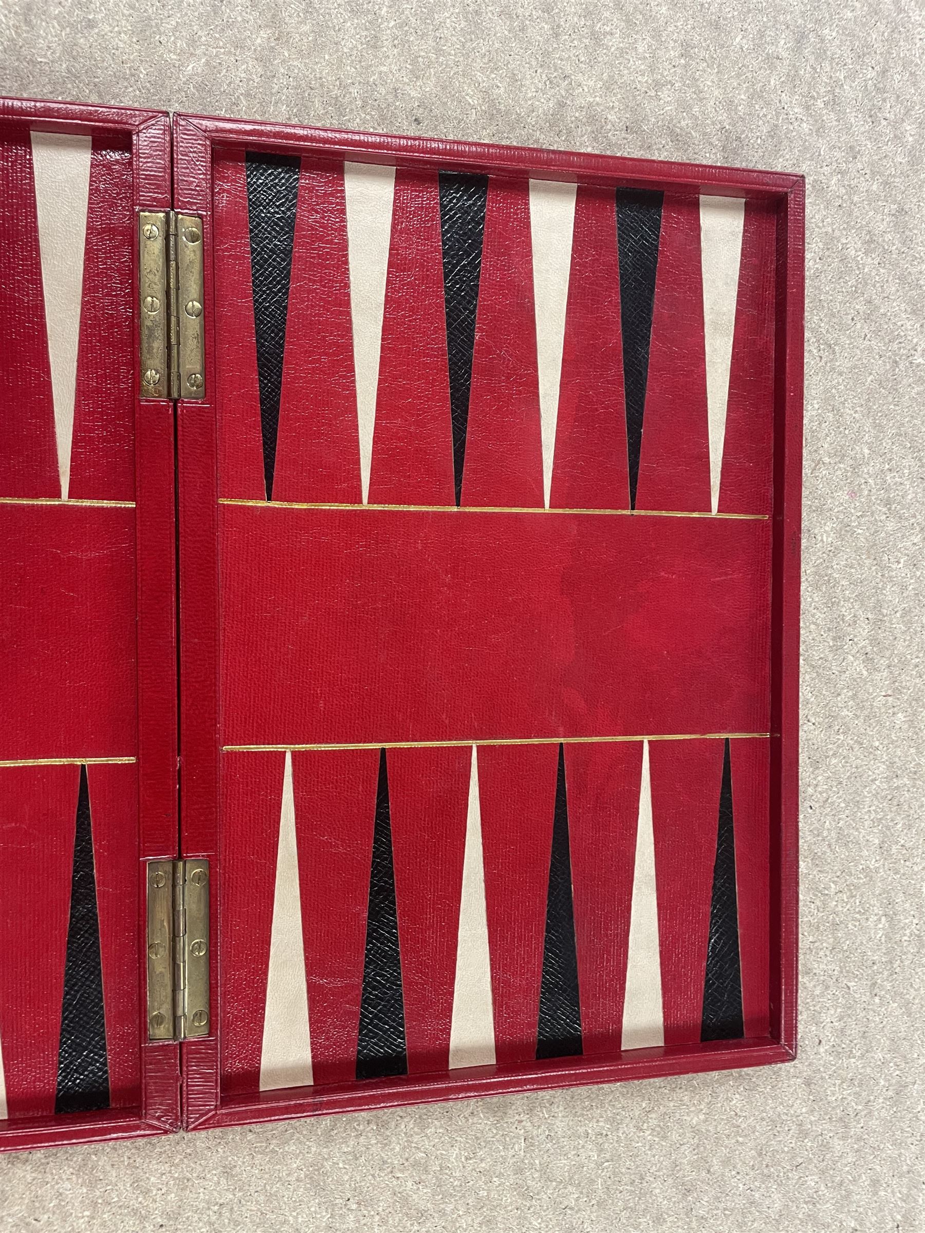 19th century walnut and brass bound games compendium box, painted to enhance the grain, of rectangular form, the hinged opening cover with rounded sides, central brass cartouche with engraved lion crest, and brass riveted straps, opening to reveal a red leather and blue silk lined compartmented interior, with fold-down games board, and lift-out tray containing playing cards, ebony turned dice towers, white and red stained bone draughts, and chess pieces, ivory dice, and ivory and ebony whist markers, and brass bezique board, cribbage board and markers, H15cm W32cm D24cm
This lot has been registered for sale under Section 10 of the APHA Ivory Act