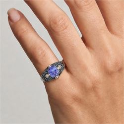 9ct white gold tanzanite and diamond ring, single oval cut tanzanite of approx 1.70 carat, surrounded by four single cut white diamonds and pave set blue diamonds, hallmarked