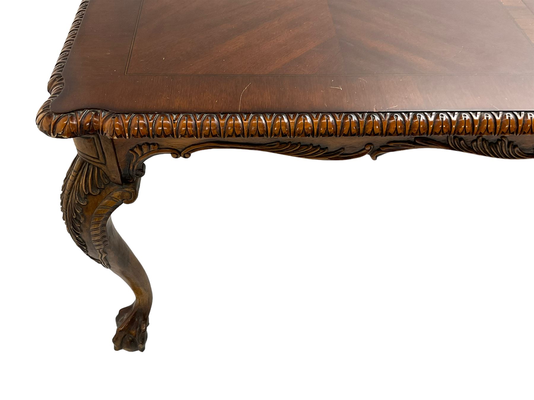 Chippendale Revival - hardwood extending dining table, rectangular gadroon carved top, on acanthus carved cabriole supports with ball and claw feet, with two additional leaves; together with a set of eight (6+2) dining chairs, shaped cresting rail over pierced and carved splat, upholstered drop-in seat, on acanthus carved cabriole supports with ball and claw feet