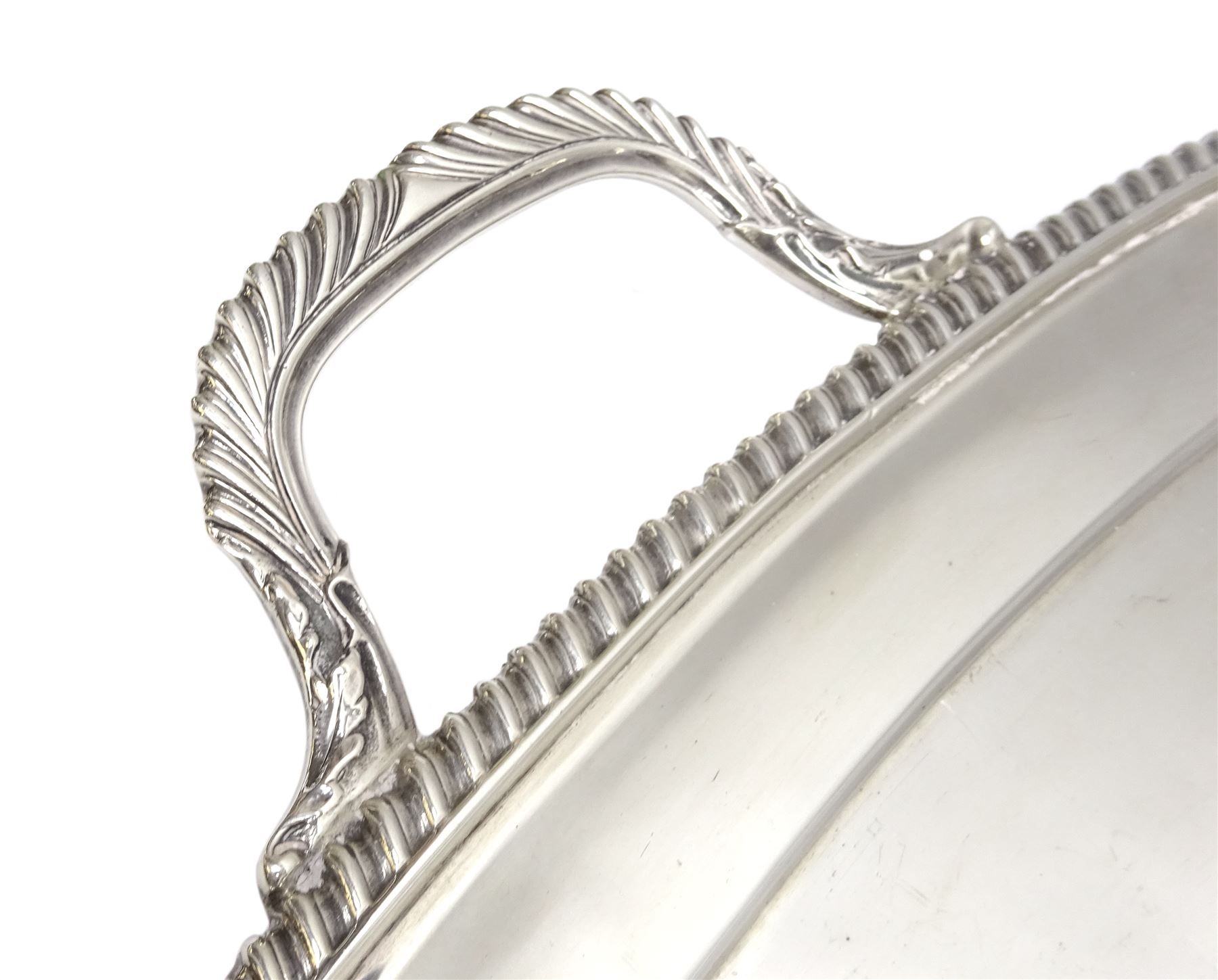 Raich Carter - presentation hallmarked silver two-handled tray of rounded oblong form with gadrooned rim by Wilson & Gill, 139 Regent Street, London, inscribed to the centre 'Presented to Mr. & Mrs. Raich Carter by the Lord Mayor of the City and County of Kingston-upon-Hull Alderman R.E. Smith J.P. on May 30th 1952on behalf of the many Admirers who subscribed to The Lord Mayor's Testimonial Fund in recognition of Raich Carter's genius as a footballer and his services to the City', London 1937 82oz L61cm; together with a hallmarked silver four-piece tea and coffee set by Cooper Bros. & Sons Ltd, the teapot of London shape with ebonised handle and knop, each piece engraved with an initial 'C', Sheffield 1920  60.5oz, teapot L29.5cm