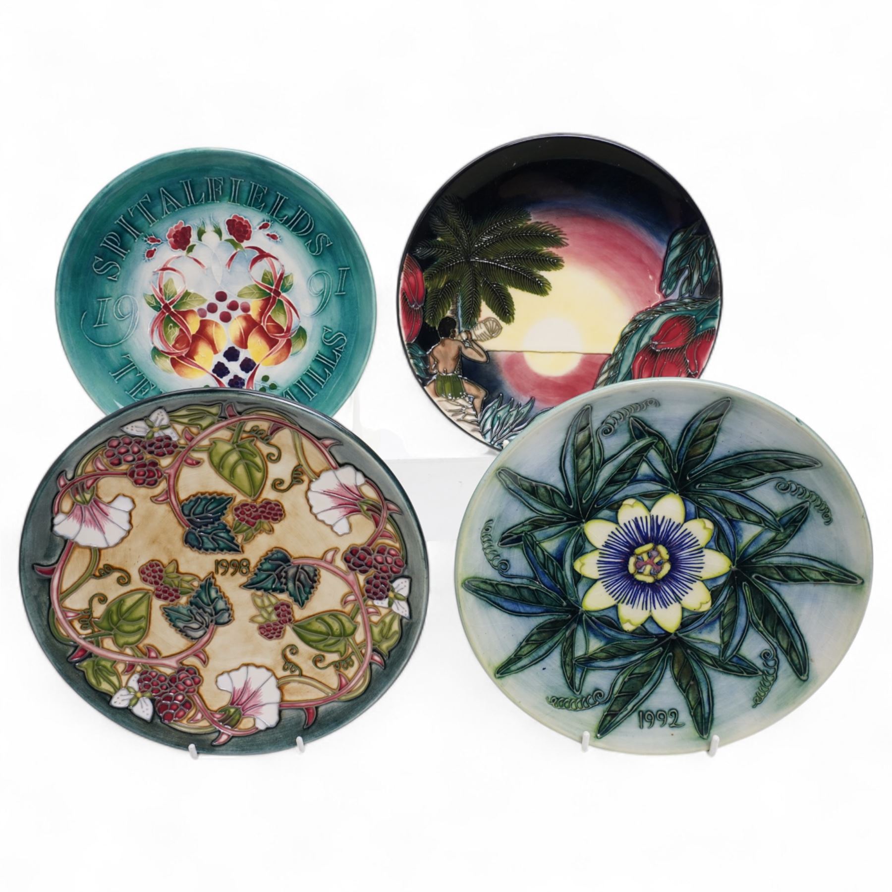 Moorcroft limited edition Birth of Light pattern millennium year plate, numbered 699/2000, impressed and painted marks to base; together with three other year plates comprising 1998, 1992 and Spitalfields Temple Mills edition 1991 plate (4)