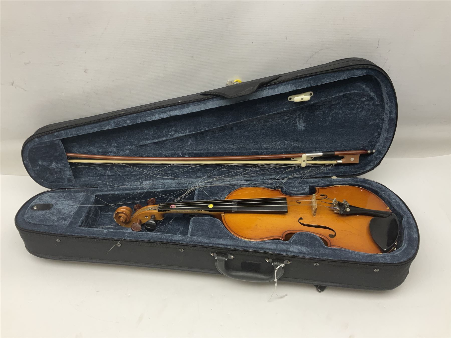 Four Chinese graduated violins - full size with 35.5cm two-piece back; three-quarter size with 33.5cm two-piece back; half size with 31cm two-piece back; and quarter size with 27.5cm two-piece back; all cased except full size; one with bow (4)