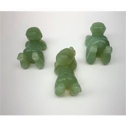 Three carved jade figures modelled as babies, approximately L5cm. (3). 