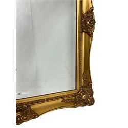 Victorian design gilt framed mirror, frame with scrolling foliate decoration (101cm x 69cm); with another similar with bevelled plate (75cm x 64cm)