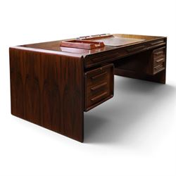 Dyrlund - Santos rosewood office suite, comprising an executive desk and cream leather upholstered swivel chair, the desk with a broad rectangular top with rounded corners, leather writing surface, pen compartments and letter tray, three lockable frieze drawers with fitted interiors above a central kneehole flanked by floating drawer pedestals, the left housing a filing drawer and the right three compartmented drawers, with a full width modesty panel to the reverse, chair raised on a castor base, H 116cm, W 62cm, D 74cm