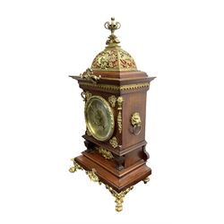 Lenzkirch - Edwardian German 8-day  mantle clock in an oak case with brass mounts and a pierced dome pediment with finial, silvered dial with Arabic numerals, gilt hands and dial centre, rack striking movement, striking the hours and half-hours on a coiled gong. With pendulum and key.