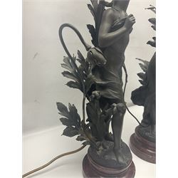 Pair of Art Nouveau style spelter figural table lamps, each mounted on rouge marble effect circular bases, with toleware flower heads and leafy decoration surrounding a female figure, H90cm