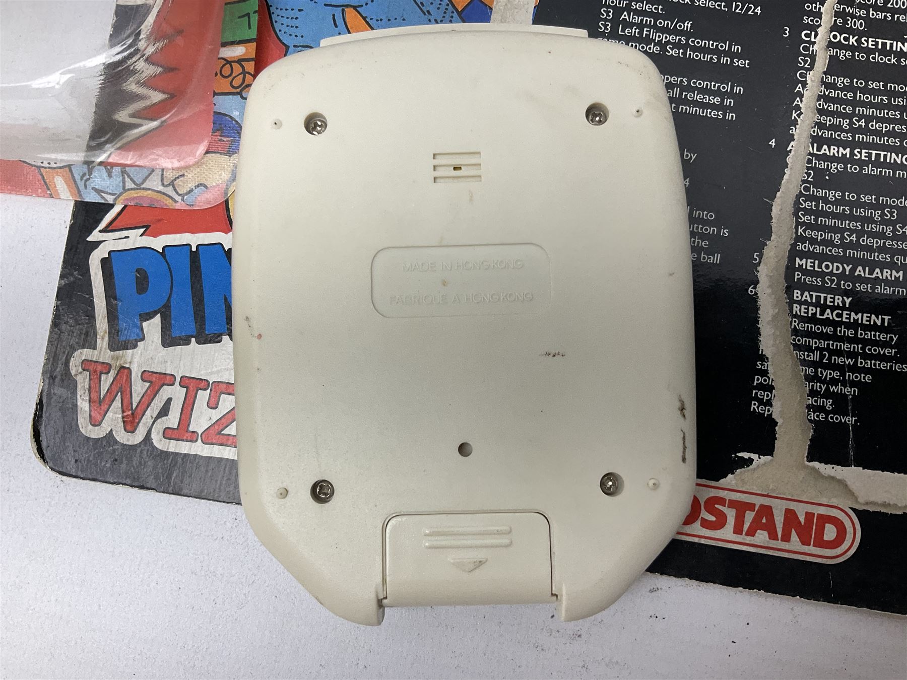 Collection of retro handheld games, including Nintendo Game & Watch ‘Snoopy Tennis’ (1982) and ‘Squish’ (1986) both with instruction booklets, Casio CG-600 ‘Star Invader’ with box, 3 in 1 LCD cartridge game including ‘Soccer’, ‘Invader’ and ‘Bomb Finder’ games, and two Grandstand ‘Pinball Wizard’ (1988) games, both with original boxes