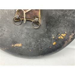 Indian black lacquered hide shield/dhal, of circular convex form with strongly outward-turned brim, fitted at its centre with four metal bosses, each of hemispherical form, with traces of silvered foliate decoration, the bosses corresponding on the inside with four iron rings for enarmes D49cm