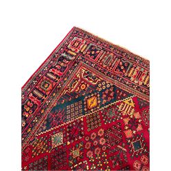 Persian Meimeh red ground rug, the field decorated with central lozenge surround by tree of life star motifs, the border with repeating design decorated with stylised plant motifs