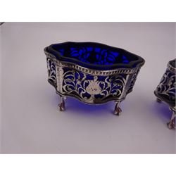 Pair of Victorian open silver salts with pierced sides, upon four ball and claw feet, hallmarked George Nathan & Ridley Hayes, Chester 1900, H5.2cm, each with blue glass liner