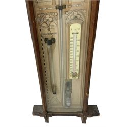 Oak cased Admiral Fitzroy barometer c1890 - with original full height paper scales annotated with Fitzroy's remarks and observations, brass sliding pointers above a Fahrenheit and centigrade spirit thermometer and storm glass, large bore bulb cistern tube with a mechanical sealing tap, in a fully glazed reformed gothic influenced case with chamfered moulded uprights, top, and base.
