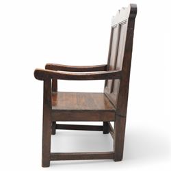 Early 18th century oak open armchair, high back with two recessed panels beneath scrolled cresting rail, curved arms and box seat, raised on square-section supports united by stretchers