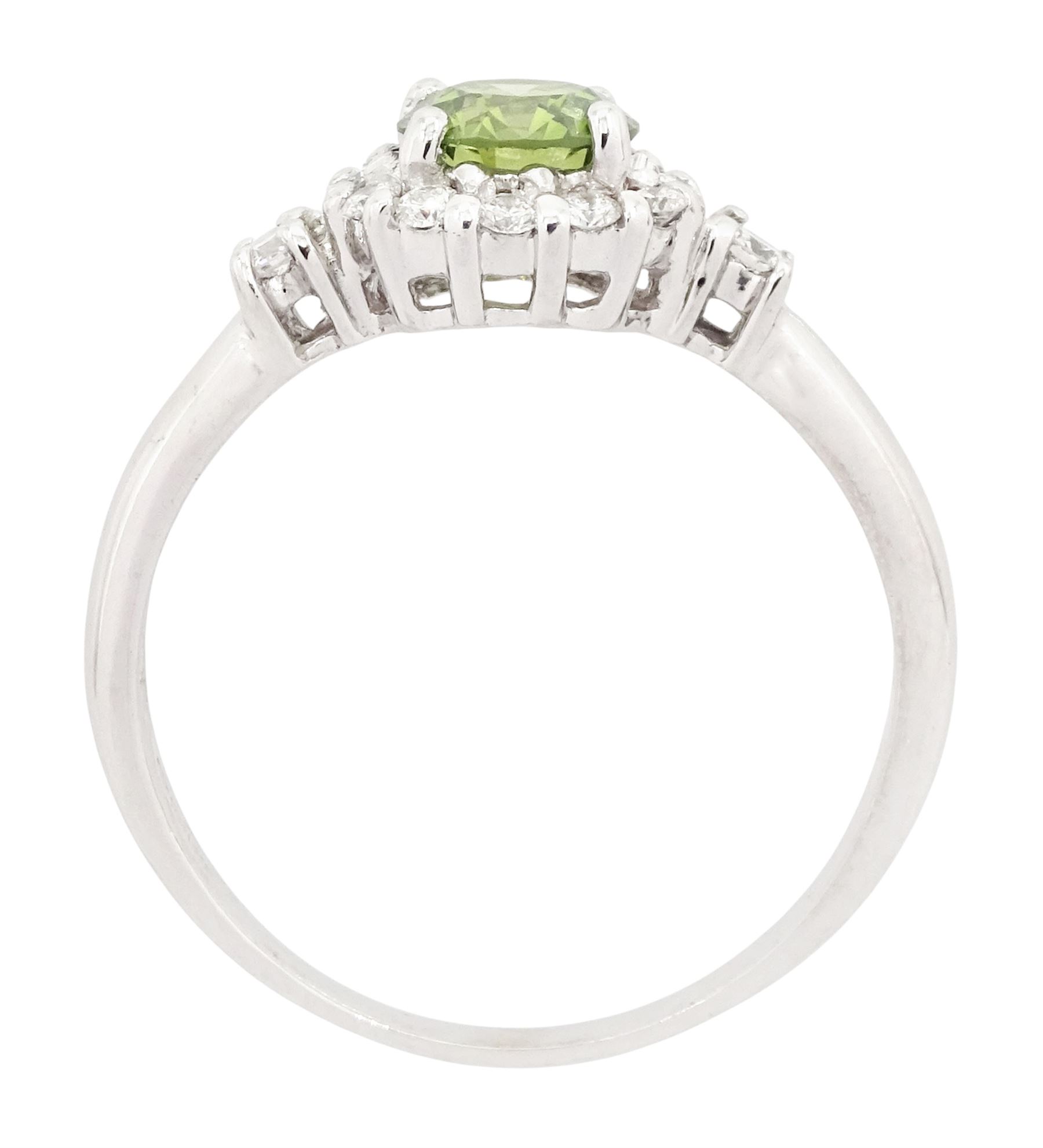 18ct white gold diamond cluster ring, the principal round brilliant cut fancy green diamond of approx 0.65 carat, surrounded by round brilliant cut white diamonds and diamond set shoulders, Birmingham 2007, total white diamond approx 0.20 carat