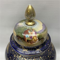 19th century Vienna style porcelain 'Musik' garniture, the central vase of baluster form with domed cover flanked by two smaller vases with twin curved gilt handles to short neck, each decorated with classical figural vignettes between blue borders heightened with gilt, H33.5cm