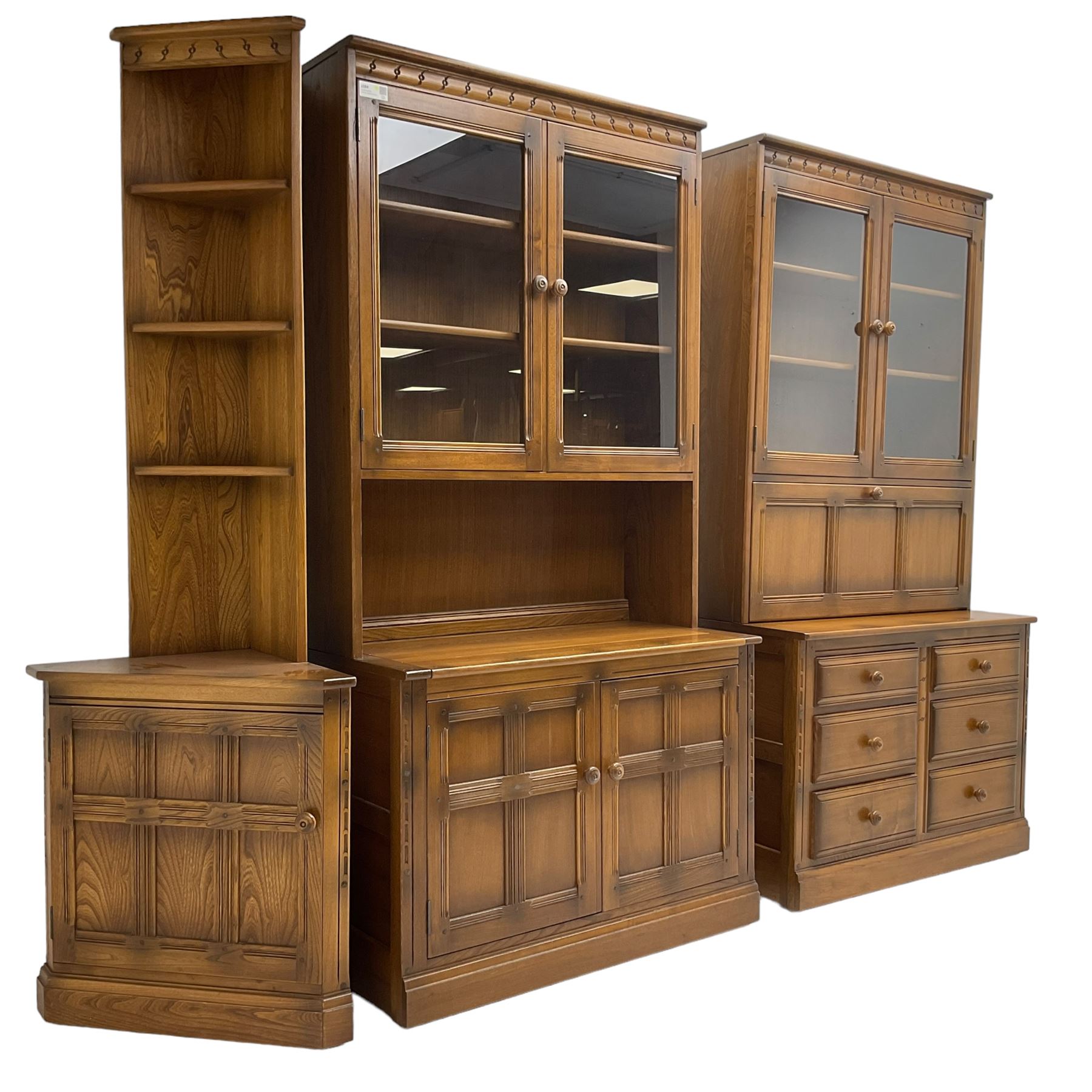 Ercol - mid-20th century dark elm 'Old Colonial' three sectional wall display unit, comprising two units and corner unit, fitted with open shelves, glazed cupboards and drawers