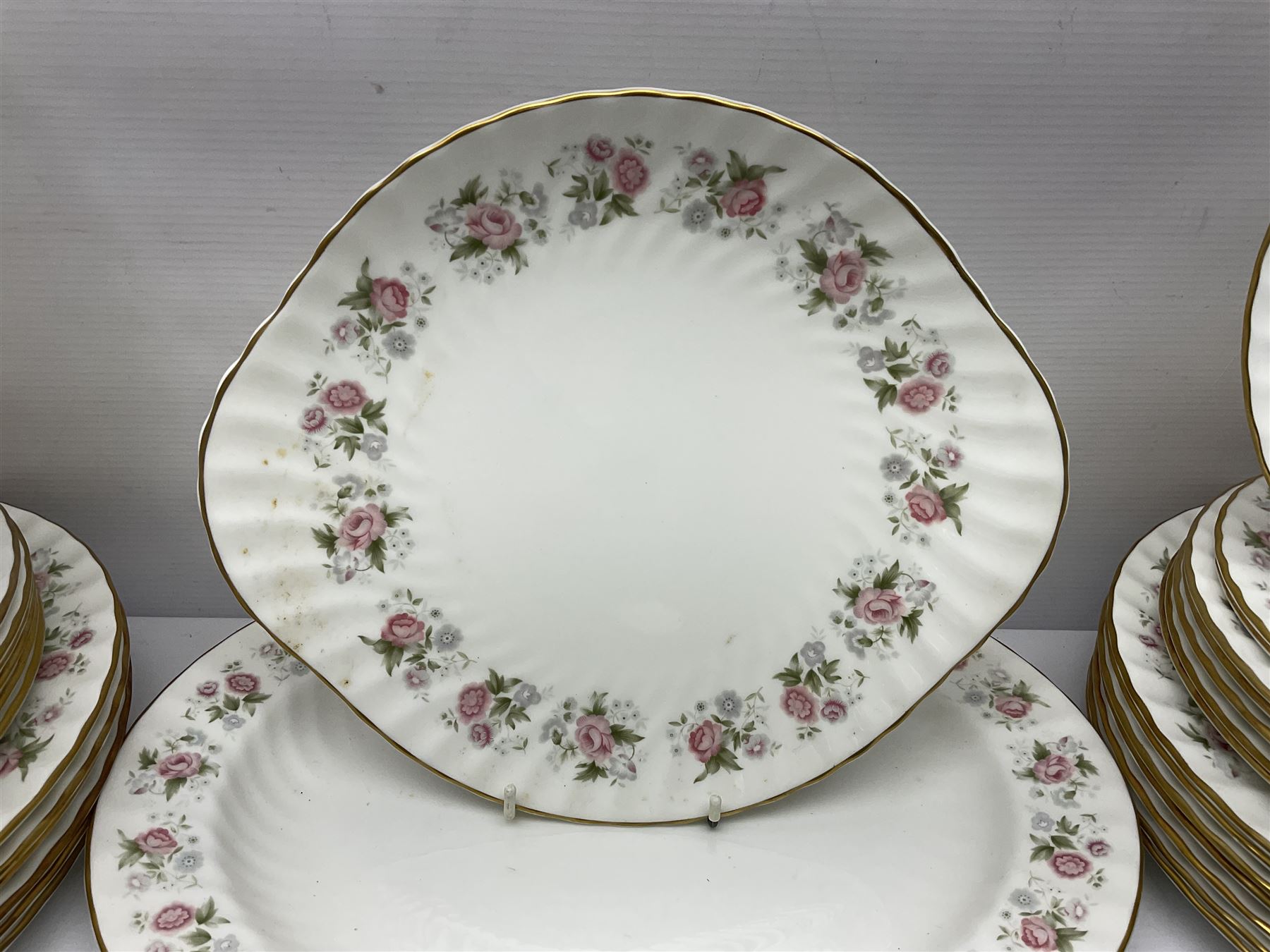 Minton Spring Bouquet pattern dinner and tea service, comprising dinner plates, twin handled tureens with covers, meat platter, teapot, milk jug, sugar bowl with cover, tea cups and saucers, bowls, cake plate, side plates, dessert plates, etc all with printed mark beneath (82)