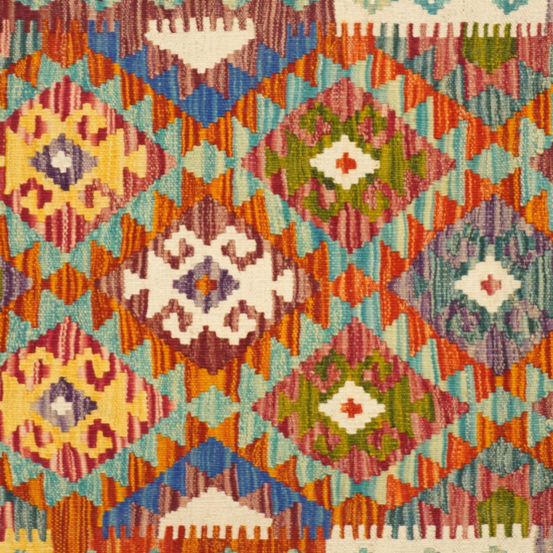 Afghan Maimana flatweave kilim runner, central field features large bold nested diamond motifs and stylized geometric lozenge patterns on olive purple, blue, and green tone ground, border stripe in mustard ground, and fringe