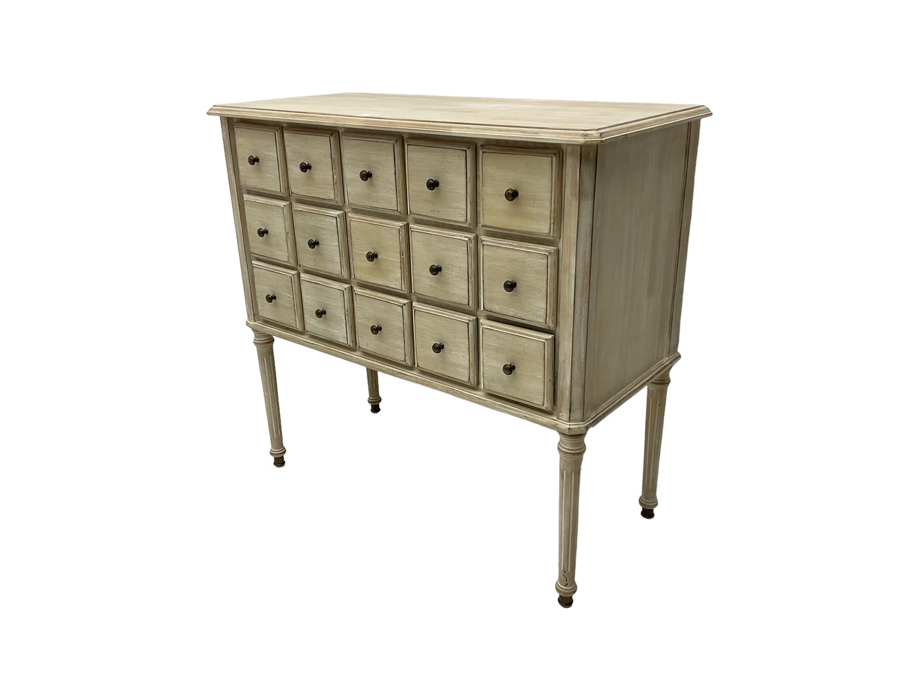 Washed finish pigeon hole or apothecary style chest, fitted with fifteen drawers, raised on fluted tapered supports 