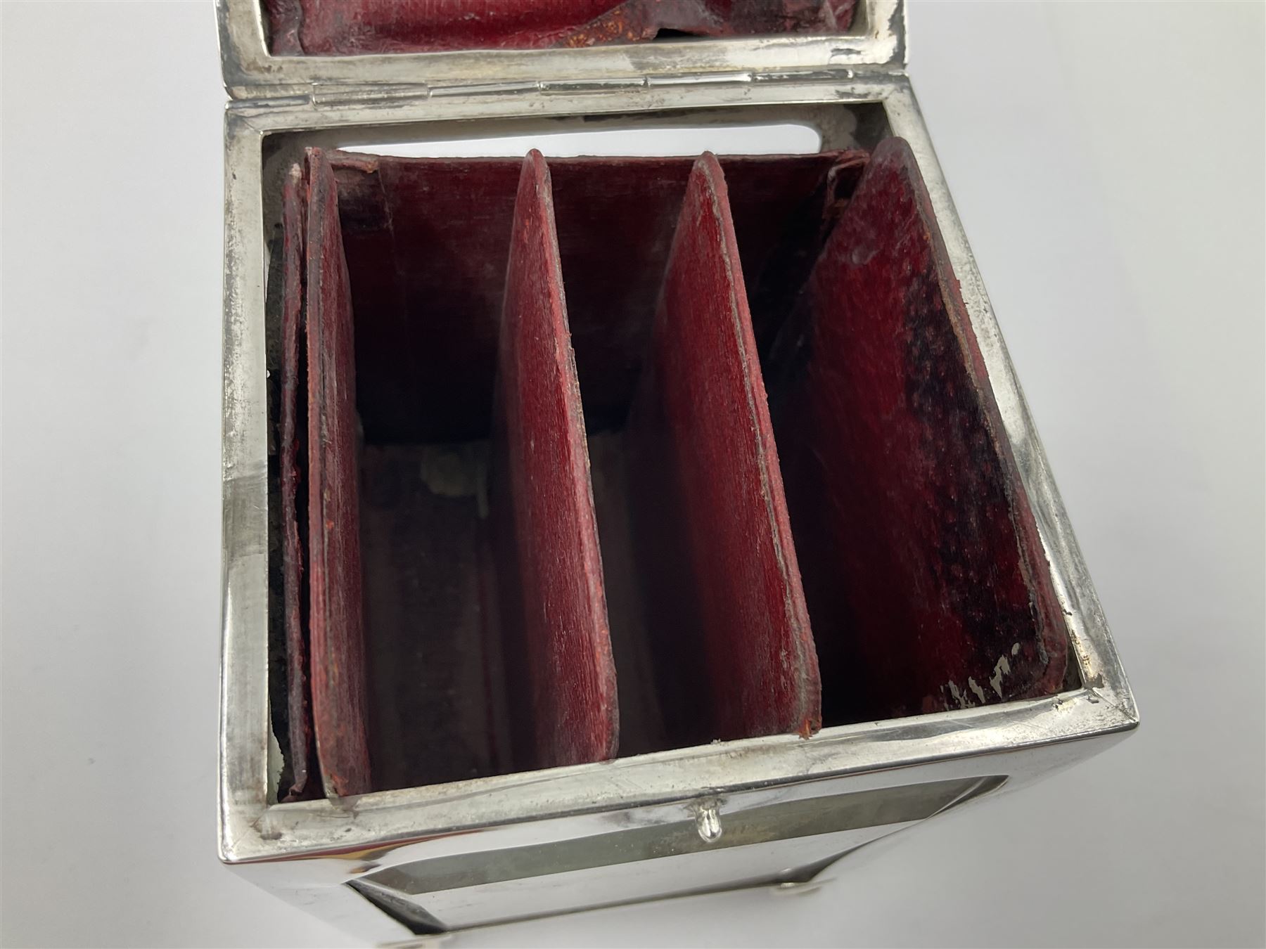 Edwardian silver mounted playing card case, hallmarked William Harrison Walter, Birmingham 1903, the sides each with a period playing card set behind a bevelled glass panel, the hinged cover with later engraving 'Presented to Norman T Crombie Esq by the officers & men of the 31st WR Detachment for services rendered 1917-1918', with red leather lined interior, the three compartments upon a sprung base and containing two later wooden Whist markers, case H12.5cm