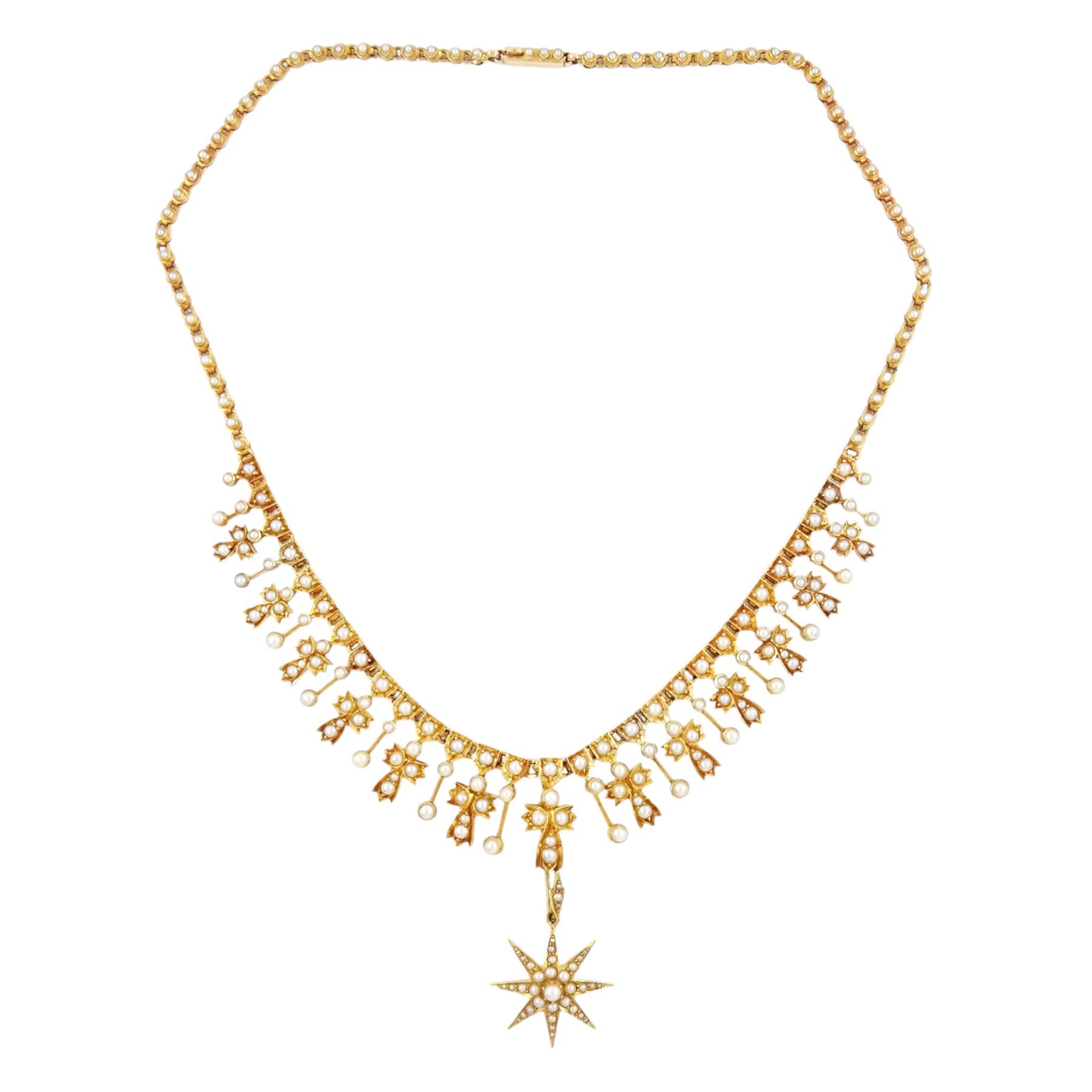 Edwardian 15ct gold split pearl fringe necklace, thirteen graduating cross pendants, each spaced by pearl drops, the centre cross suspending an 18ct gold pearl star pendant, to a pearl set chain necklace, in silk and velvet lined case by Elkington, Glasgow