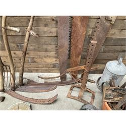 Large quantity of vintage hand tools including scales, scythes, saws etc
