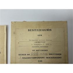 Three German documents dated 1942 - Gold Cross award to Major Ludwig Osterkampf; and Crete wound certificate and cuff title certificate awarded to Feldwebel Alfred Glaise; all unframed (3)