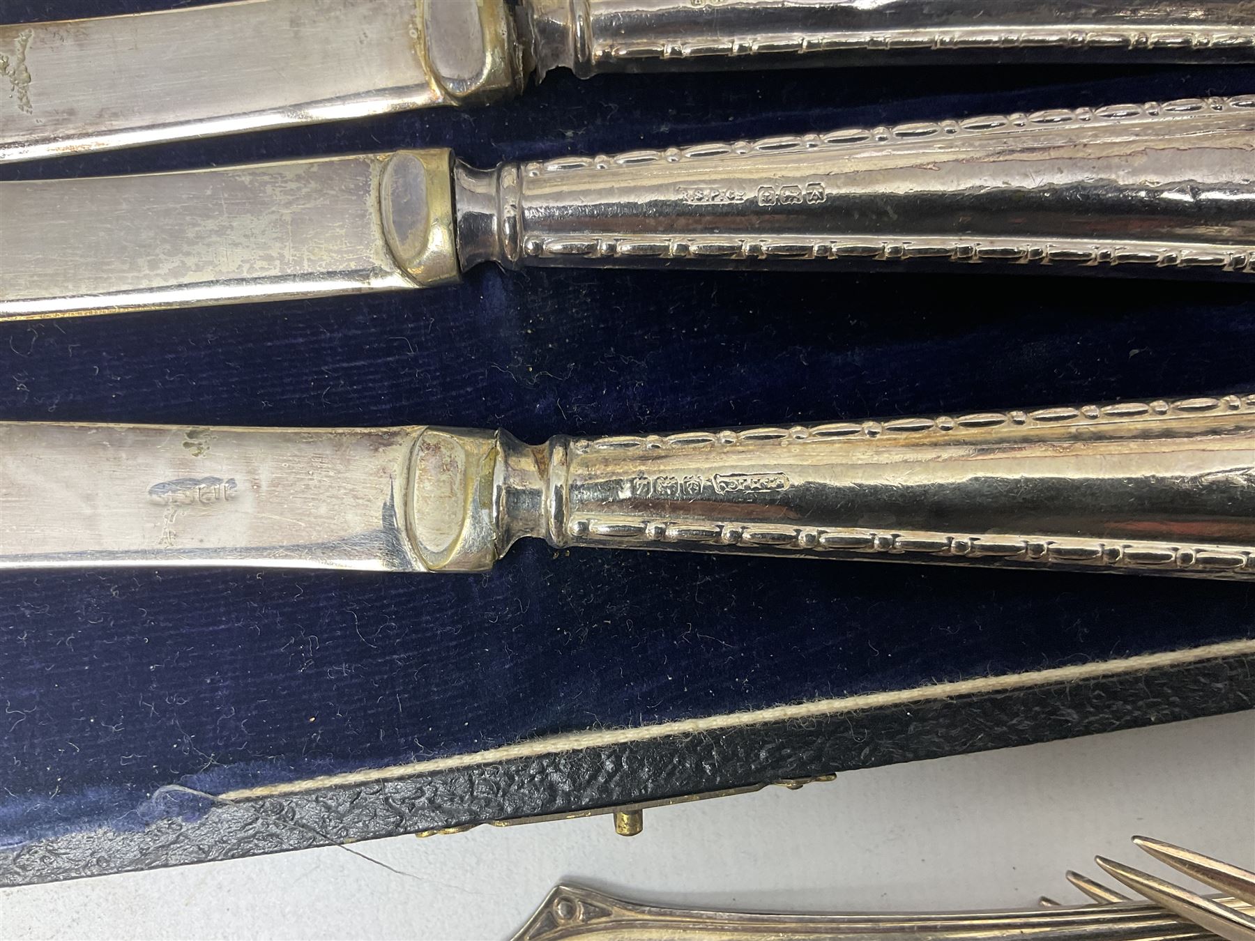 Group of silver to include cased set of six silver handled knives hallmarked Birmingham 1921 by Raeno Silver Plate Co, three hallmarked napkin rings etc together with silver plated and other metalware etc