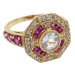  Gold ruby and diamond surround octagon dress ring, set with a central pale blue stone, stamped 10K  