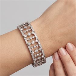 18ct white gold diamond bracelet, articulated and pierced design milgrain links set with round brilliant cut diamonds, the sides with engraved foliate decoration, stamped 750, total diamond weight approx 4.15 carat