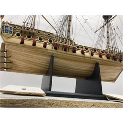 Wooden kit built model of HMS Neptune, 1:90 scale, with detailed rigging to three masts and a row of cannons to either side, upon ebonised wooden base, including stand H71cm