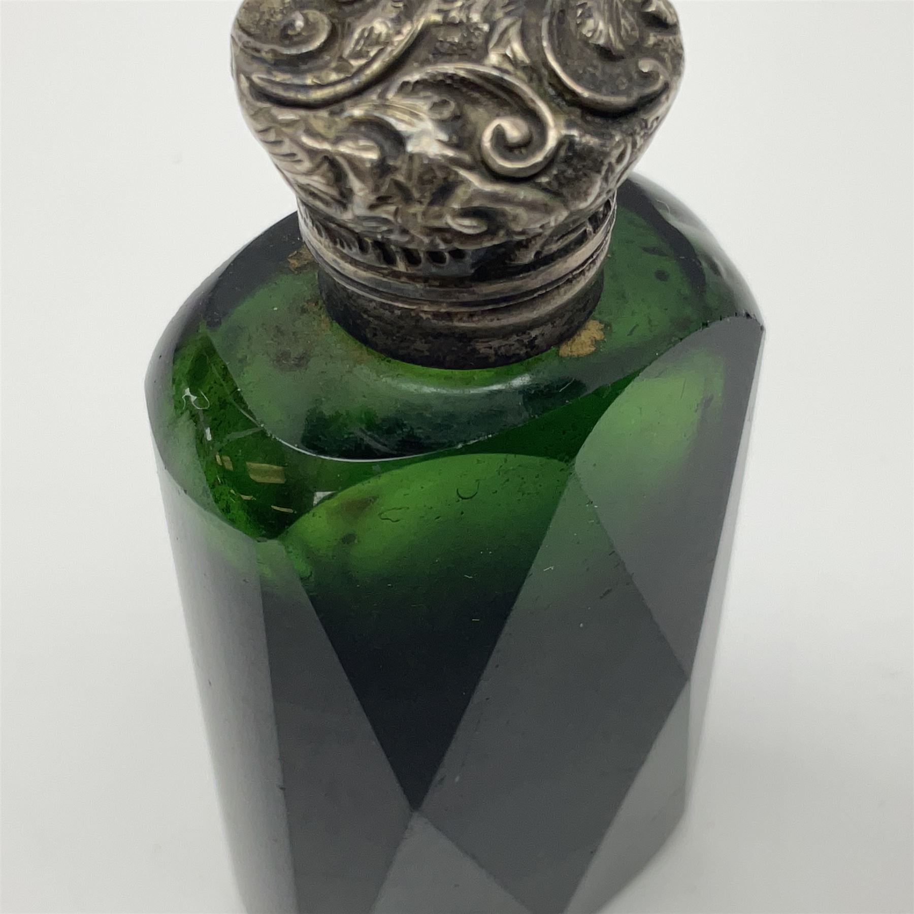 Silver mounted green glass scent bottle, with original stopper, and embossed silver cover, H7cm