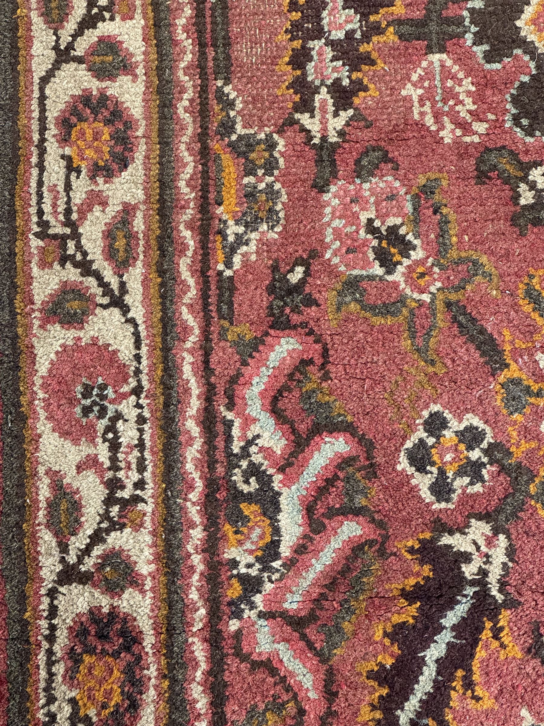 Belgian Sultan woollen ground rug, central navy field densely decorated with floral sprays and geometric patterns (192cm x 135cm); handwoven tribal terracotta ground rug (121cm x 71cm); Persian crimson ground runner, all over stylised floral and foliate motifs (266cm x 94cm)
