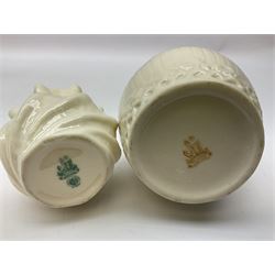 Quantity of Belleek ceramics to include mid-late 19th century jug moulded with green man mask and foliage, date code stamp for 1863-1890, together with later Belleek cornucopia shape vase, jug and other vases together with a Belleek style shell dish raised on branches, tallest H19cm