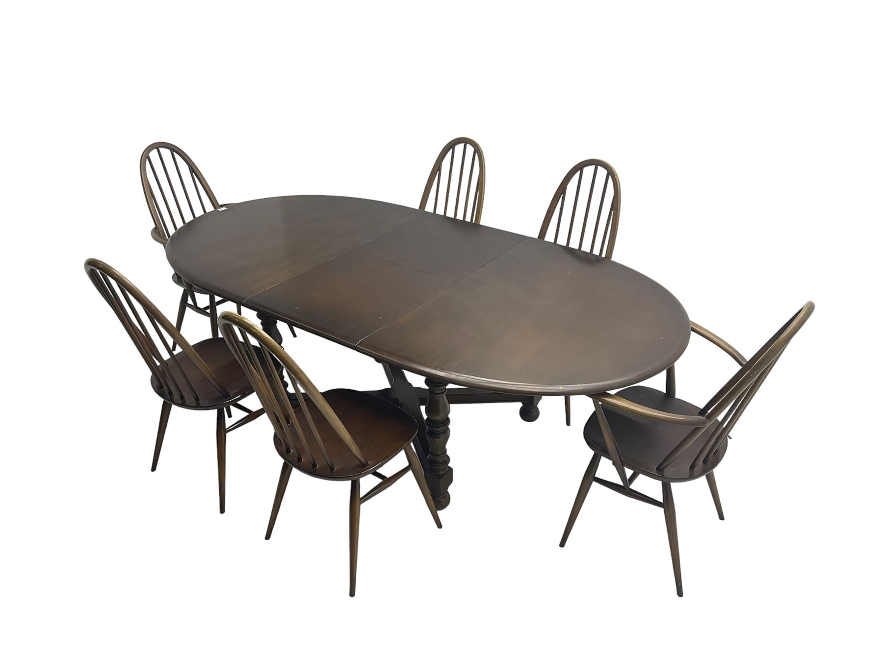 Ercol - 'Old Colonial' 705 elm extending dining table, oval top with hidden leaf, raised on turned supports united by X-stretcher (W163cm D108cm H72cm); and Ercol - set six  (4+2) dark elm 'Quaker Back Windsor Dining Chairs', hoop and stick backs 