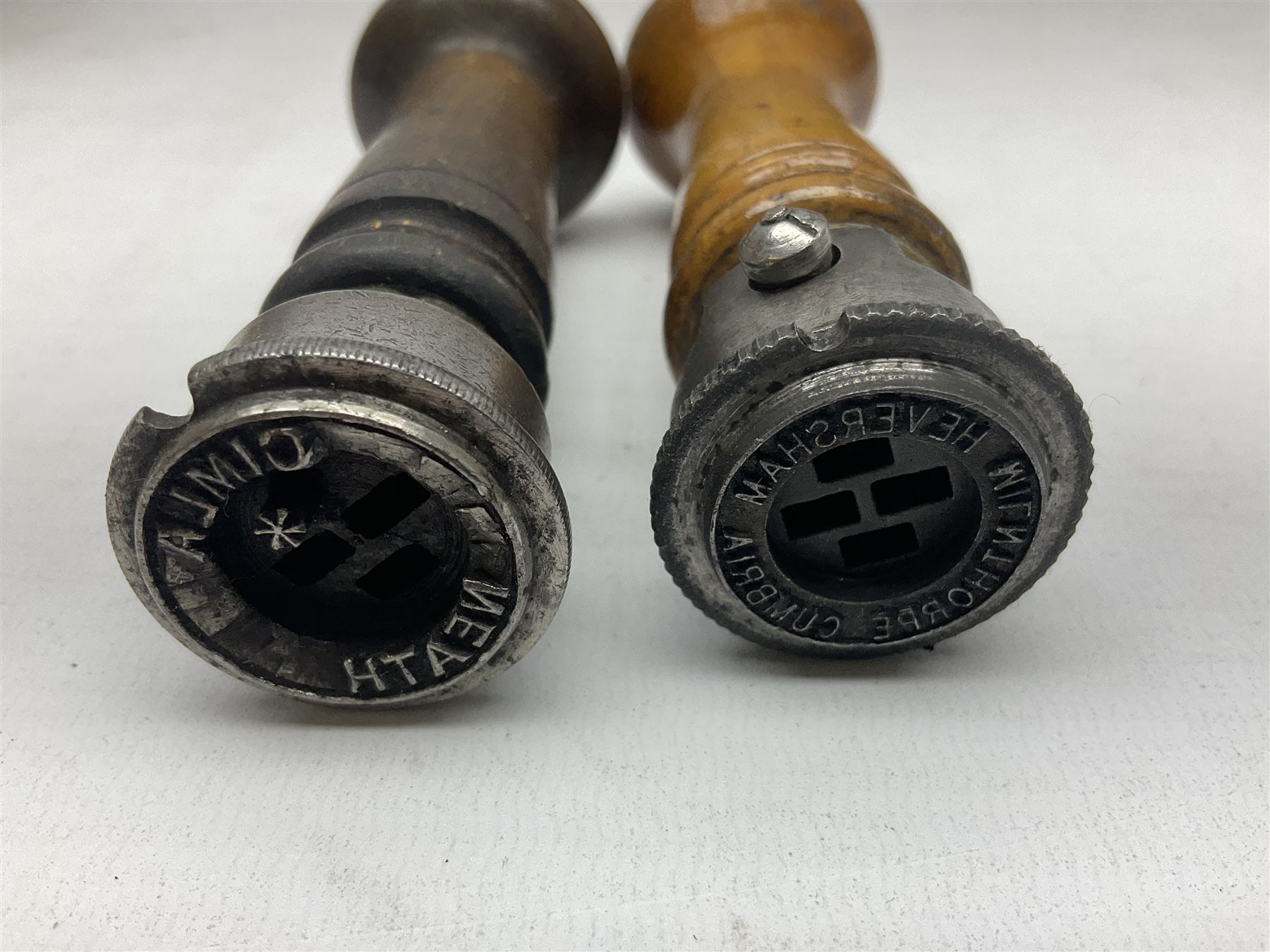 Two Post Office hand stamps 'Heversham Milnthorpe Cumbria' and 'Cimla Neath', together with two hand stamp bodies and various date numbers, housed in a fitted box