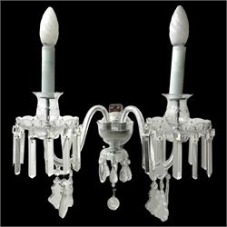 Pair of cut glass two branch wall sconce candelabras, each with S scroll extending branches with shaped and bevelled circular drip trays, hung with pendant drops