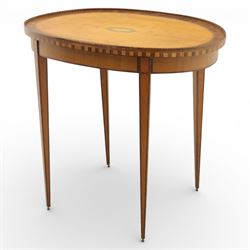 Early 19th century Sheraton revival satinwood oval table, shell motif to the centre bordered by walnut veneer, with inlaid banding, supported on square tapering legs terminating in brass feet