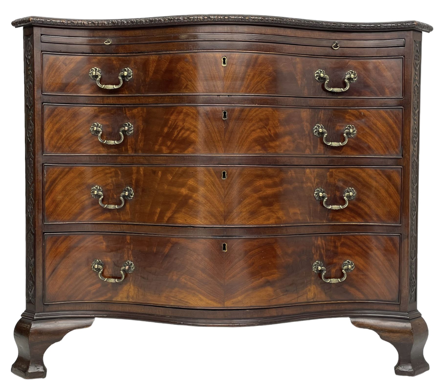 Chippendale design serpentine chest, shaped moulded top carved with repeating flower head motifs, fitted with brushing slide over four graduating drawers, pierced and foliate moulded handle plates with scrolled swan neck handles, canted upright corners carved with flower heads and strapwork, on canted ogee bracket feet