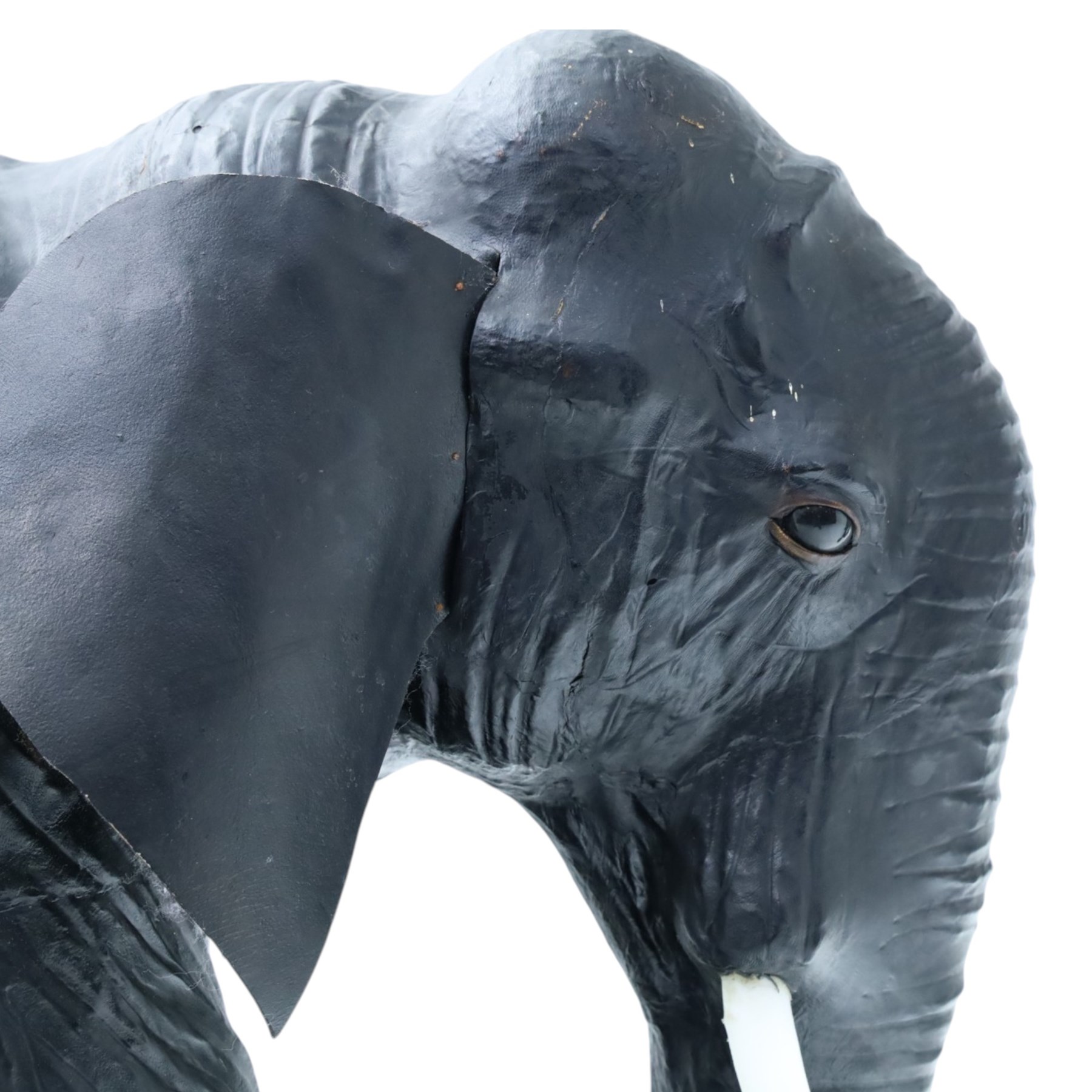 In the style of Liberty & Co - pair of 20th century ebonised leather elephants