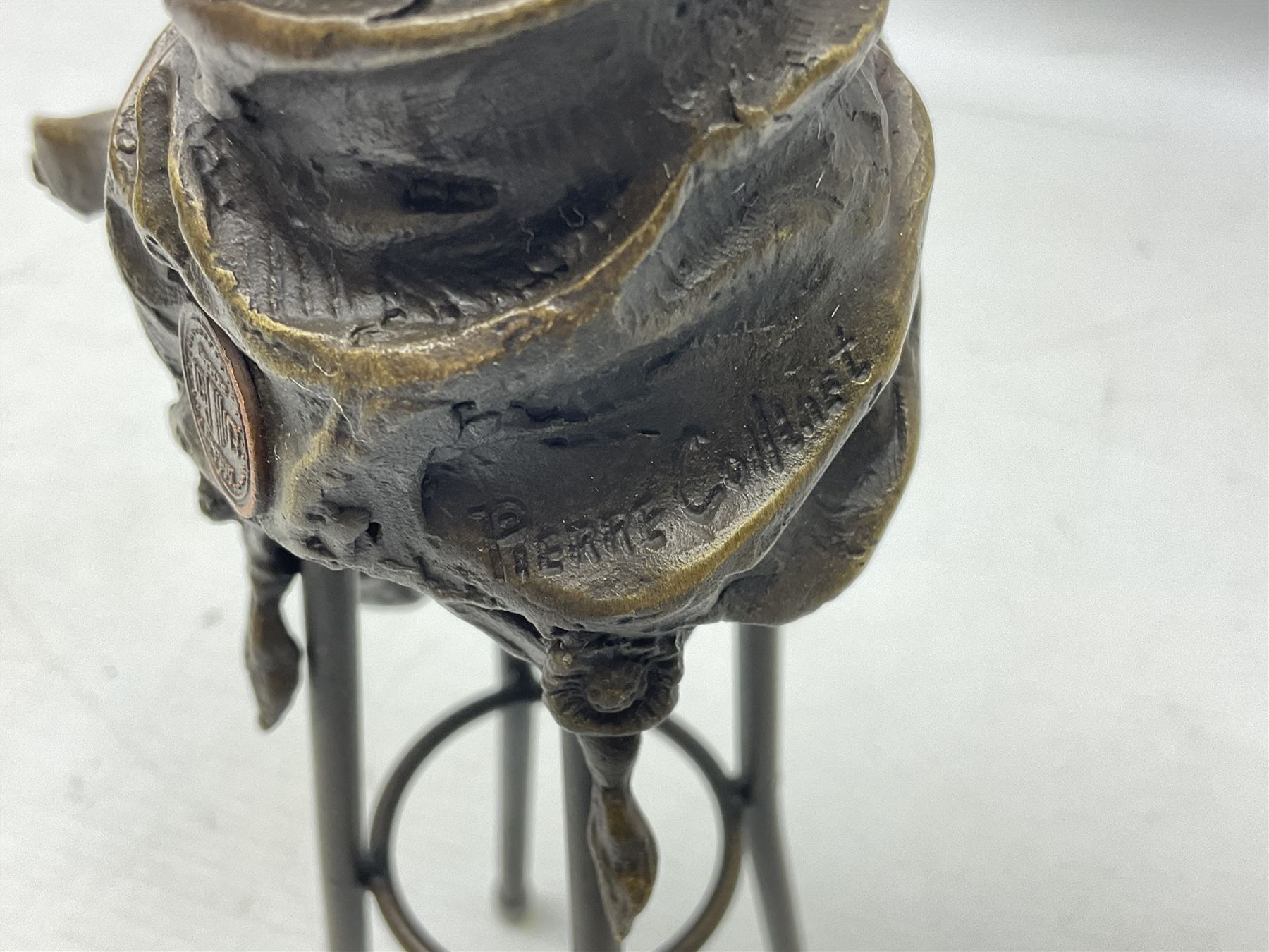 Art Deco style bronze modelled as a female figure seated upon a chair holding an apple, after 'Pierre Collinet', H28cm