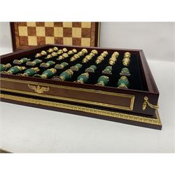 Franklin Mint House of Faberge 'The Imperial Jewelled Chess Set', to include set of chess pieces with malachite finish and a set with carnelian finish and a hardwood chess board
