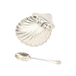 Edwardian silver shell butter dish, upon three bun feet, together with a matching shell spoon engraved with initial, both hallmarked Josiah Williams & Co, London 1906 and 1914, together with an Edwardian milk jug, open sucrier and sugar tongs, the jug and bowl of circular part fluted form with bead rim, hallmarked Mappin & Webb Ltd, Sheffield 1902, both sets contained within fitted tooled leather boxes with silk and velvet lined interiors