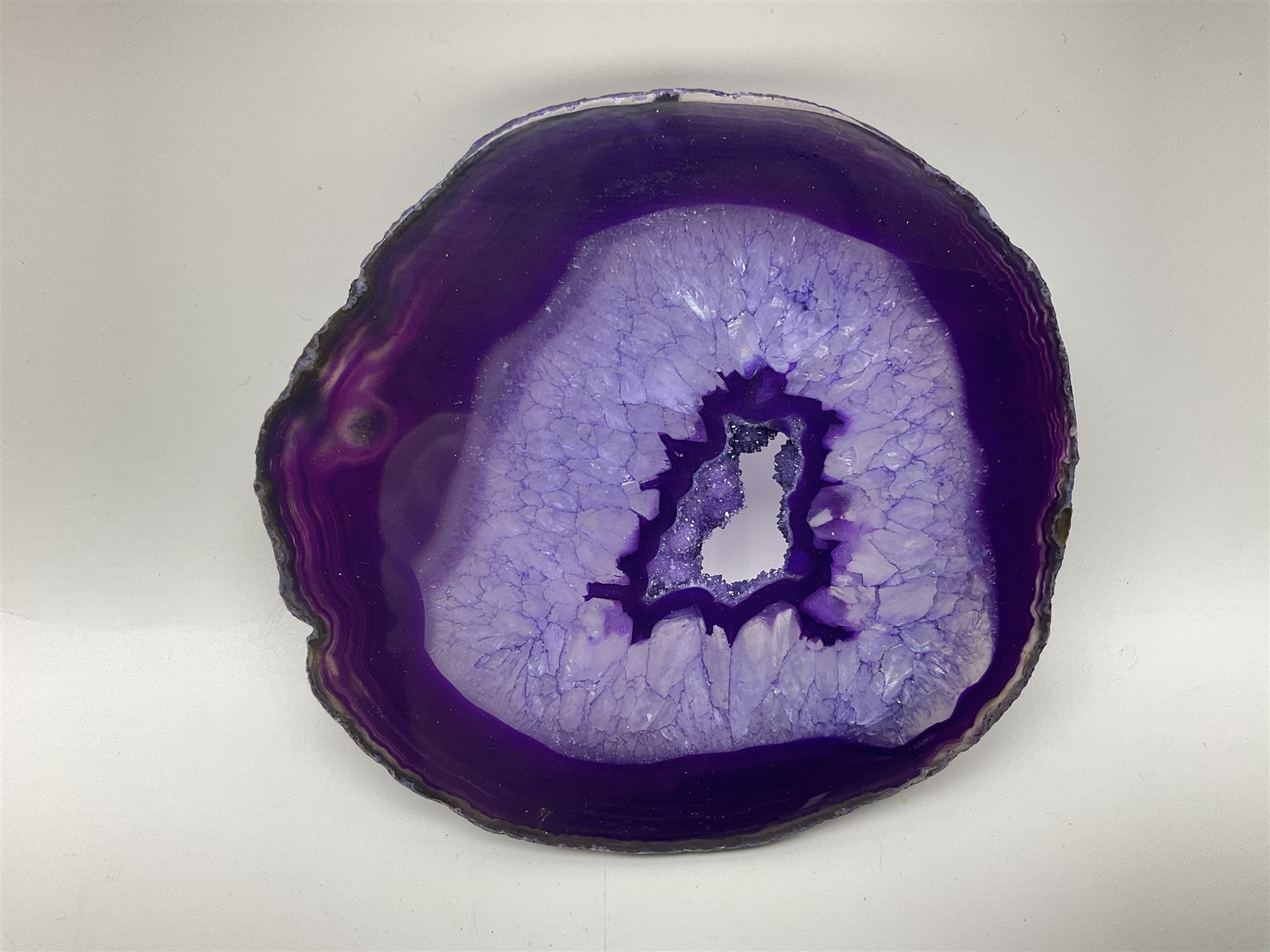 Pair of purple agate slices, polished with rough edges, raised upon gilt metal stands