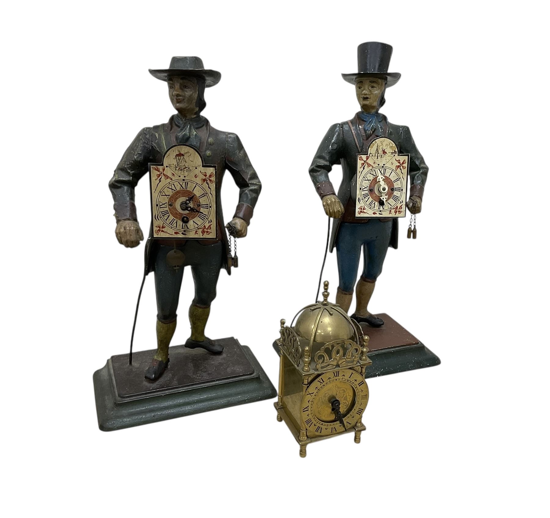Two 29th century reproduction German traveling clockmaker figures and a small battery operated miniature lantern clock