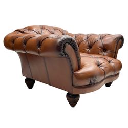 Tetrad - 'Oskar' armchair, Chesterfield shape with rolled arms, upholstered in buttoned tan leather, on turned and reed moulded feet 